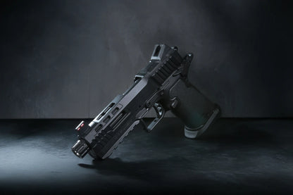 A semi-automatic airsoft pistol, identified as a Kizuna Works Basilisk shown on a dark, textured studio surface.